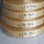 روبان طلایی 2/5 سانتی متری با چاپ مشکی DIORA تیراژ 1000 متری